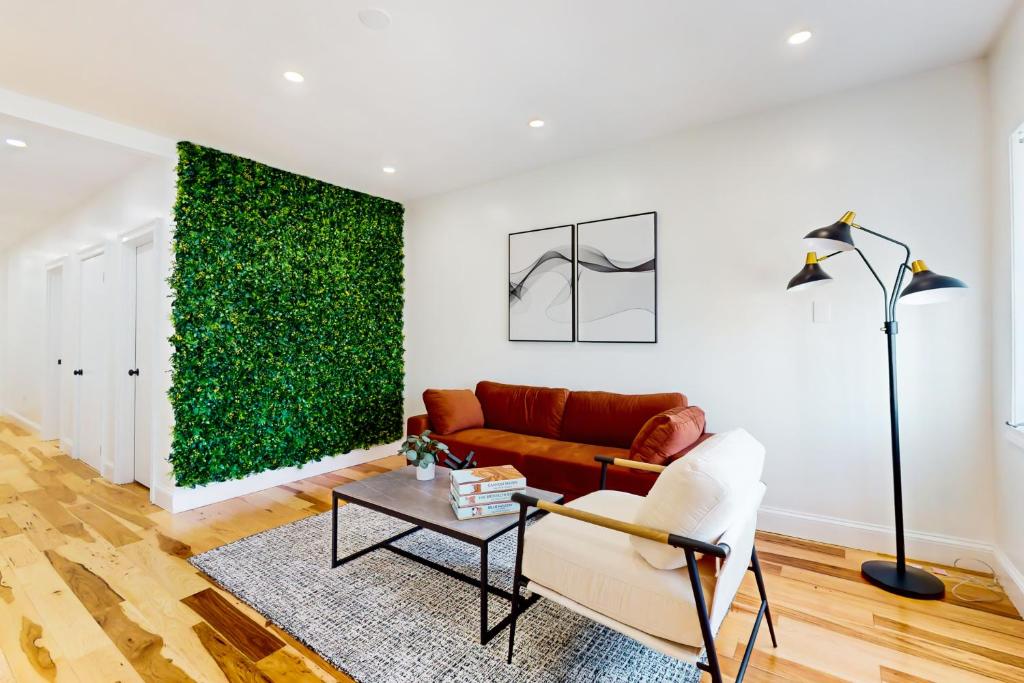 a living room with a couch and a green wall at In-between the Coast and the City in Everett