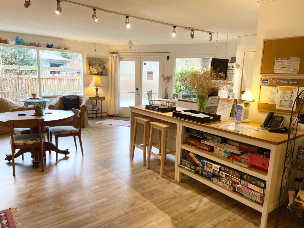 a kitchen and living room with a table and a counter at Wisteria Guest House in Ganges