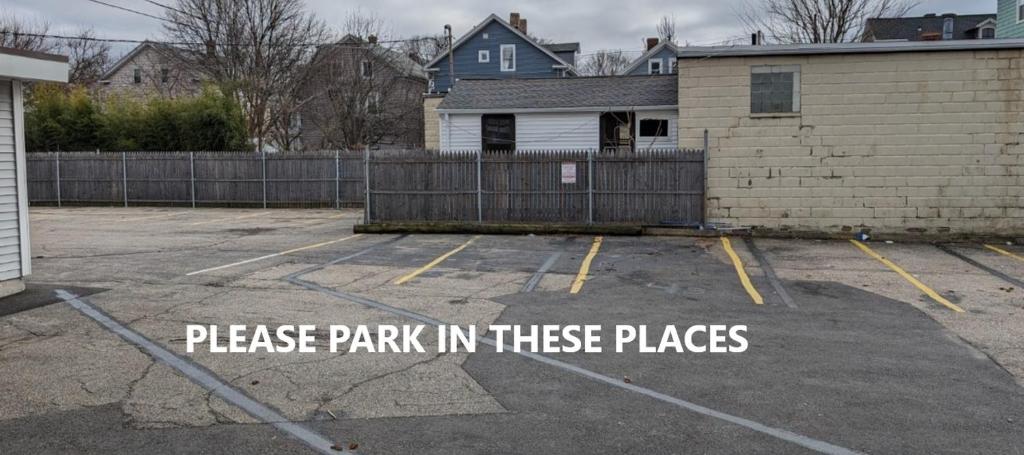 a parking lot with a sign that reads park in these places at Private room and bathroom in Providence