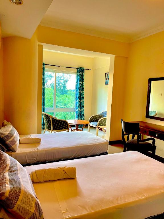 Postel nebo postele na pokoji v ubytování Sunrise Apartments-Nyali