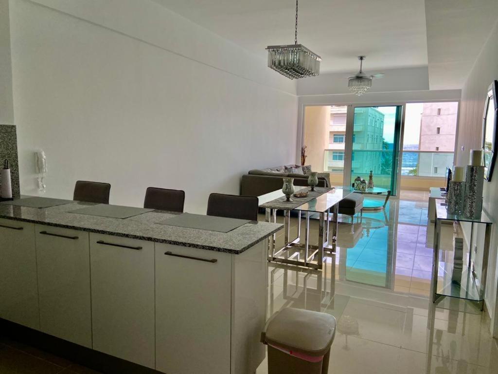 a kitchen and living room with a table and chairs at Villa parmera ocean from in Los Corrales