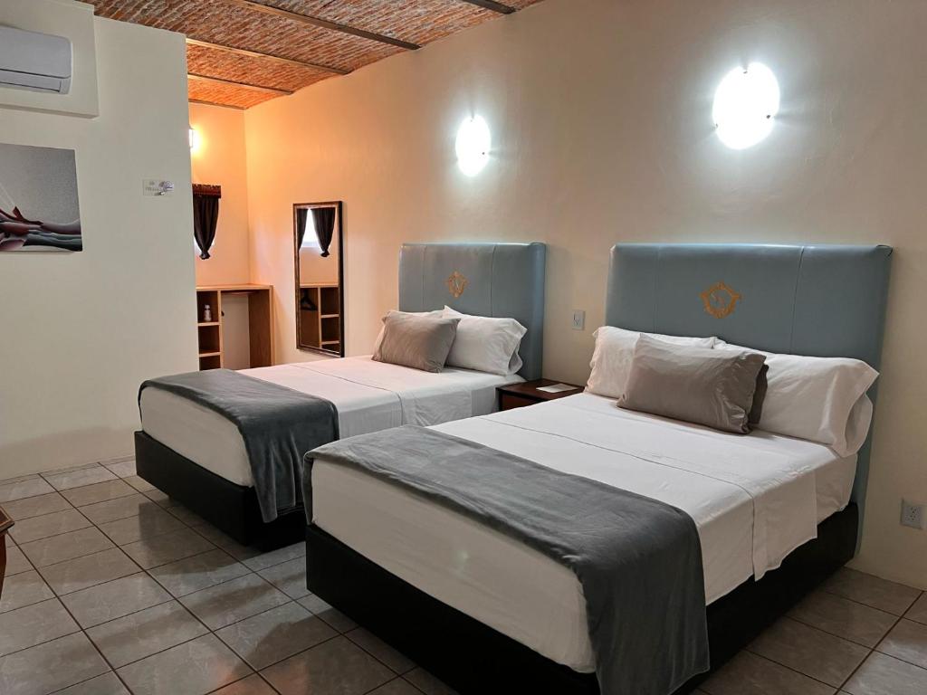Postel nebo postele na pokoji v ubytování Hotel & Eventos Xalos