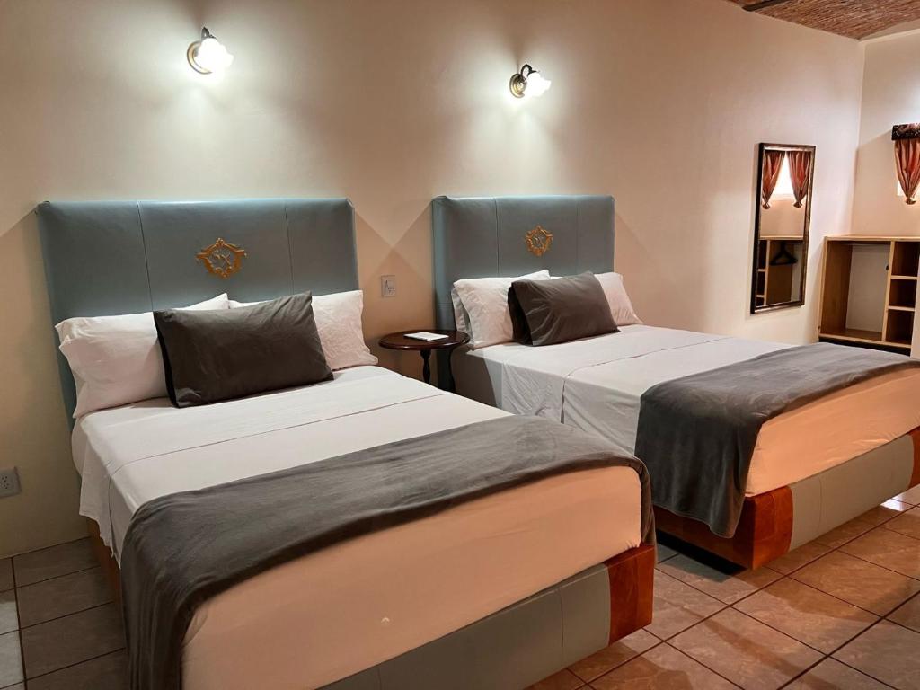 Postel nebo postele na pokoji v ubytování Hotel & Eventos Xalos