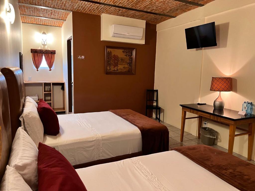 Postel nebo postele na pokoji v ubytování Hotel & Eventos Xalos