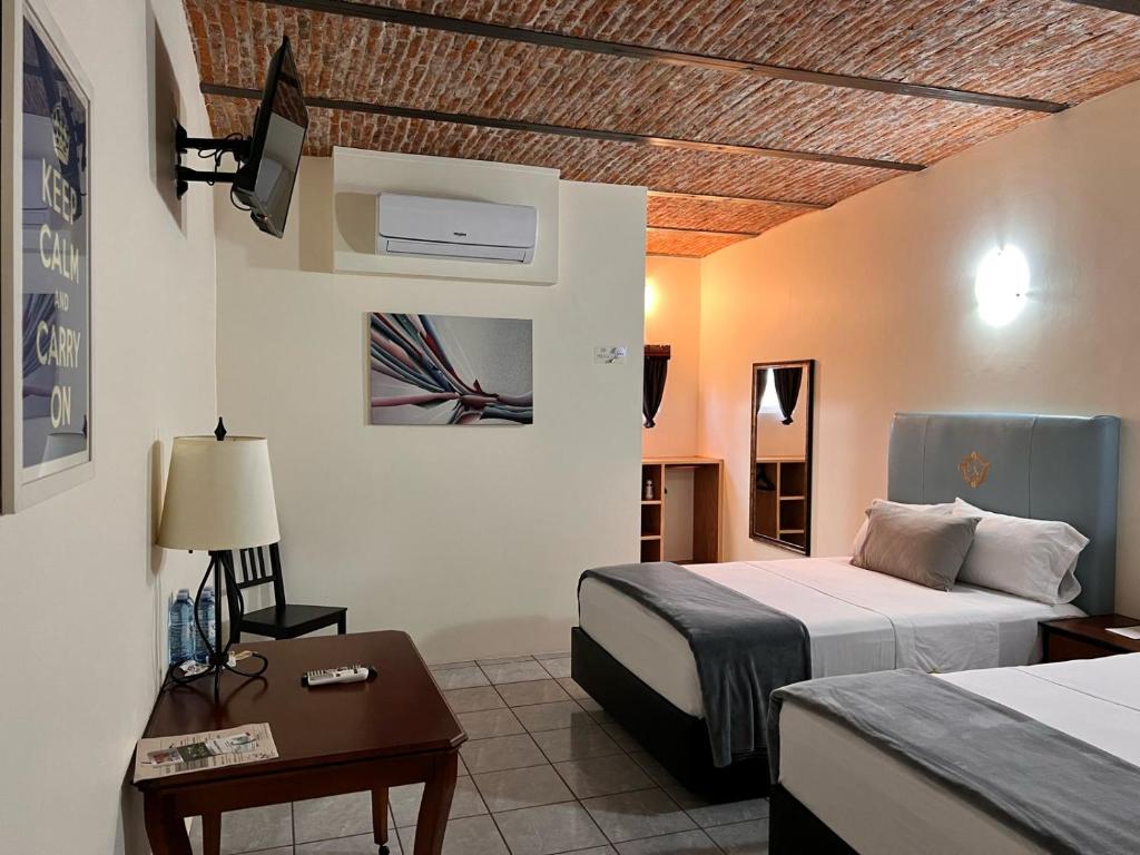 Postel nebo postele na pokoji v ubytování Hotel & Eventos Xalos