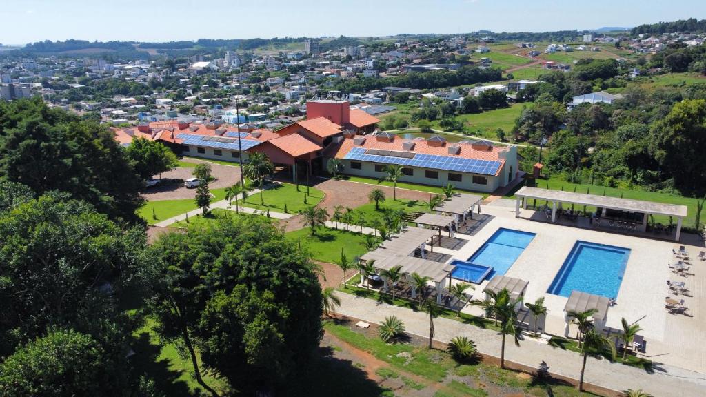 an aerial view of a building with a swimming pool at Hotel Lago Dourado in Dois Vizinhos