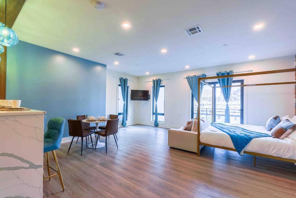 a bedroom with a bed and a dining room with a table at Spacious Suite with Free parking in Downtown, 3 beds, Dining for 6, kitchen in Apt, washer and dryer in Apt, 15 min to Airport in Newark