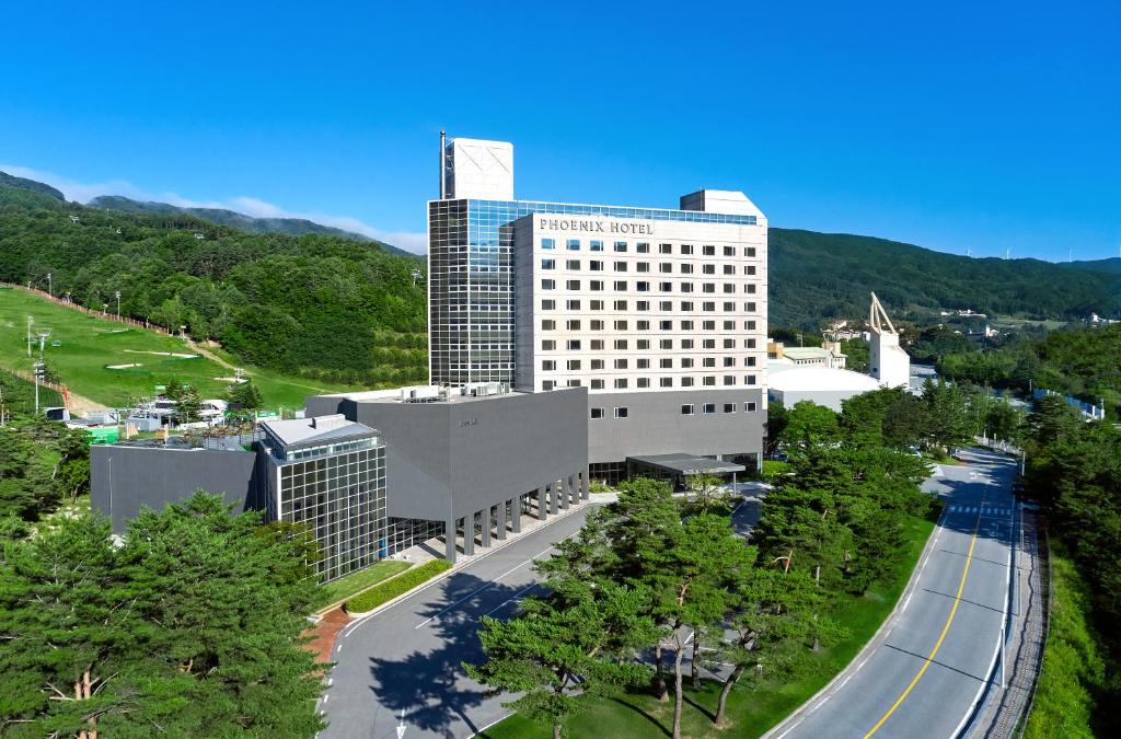 an aerial view of a building with a road in front at Phoenix Hotel Pyeongchang in Pyeongchang 