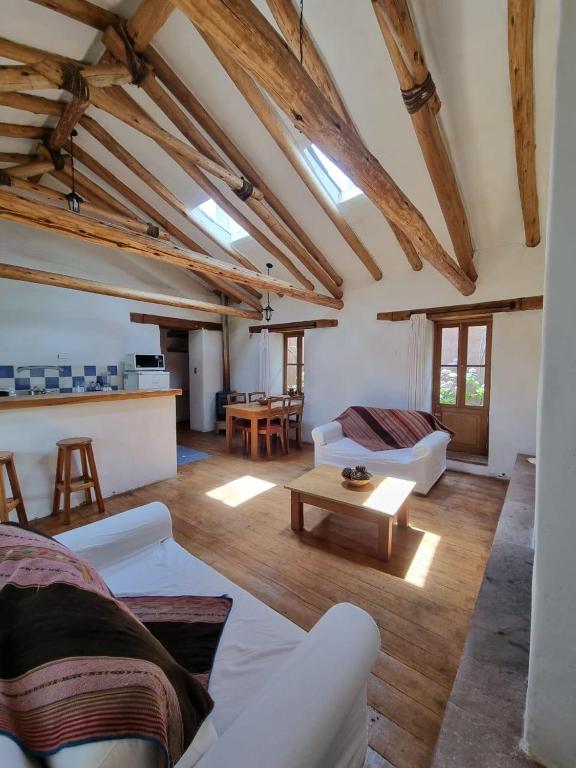 庫斯科的住宿－Magico bungalow en tambillo，客厅配有白色的沙发和桌子