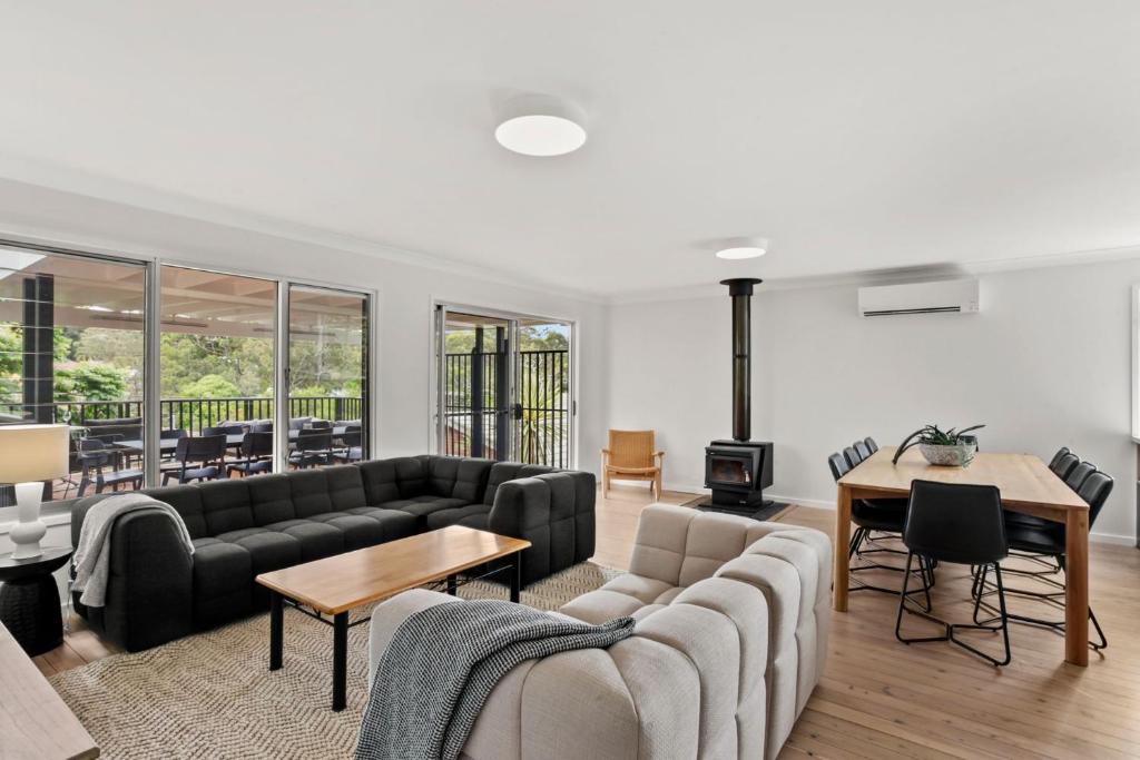 a living room with a couch and a table at Mollymook Golden Sands in Narrawallee