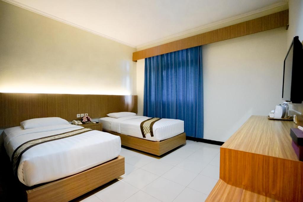Letto o letti in una camera di Cakra Kusuma Hotel