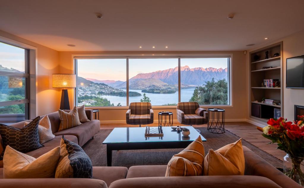 a living room with couches and a large window at Lordens Apartment 1 in Queenstown