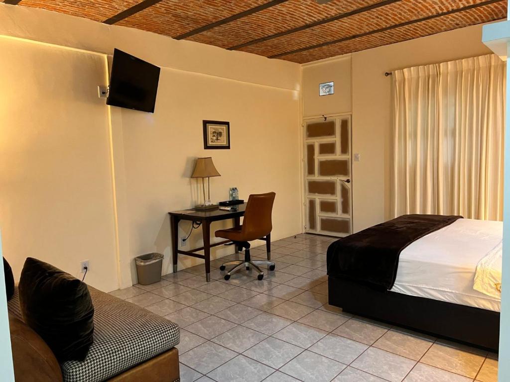 Postel nebo postele na pokoji v ubytování Hotel & Eventos Xalos