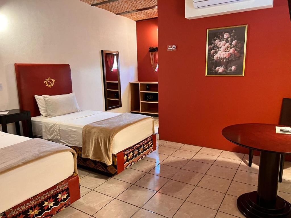 Postel nebo postele na pokoji v ubytování Hotel & Eventos Xalos