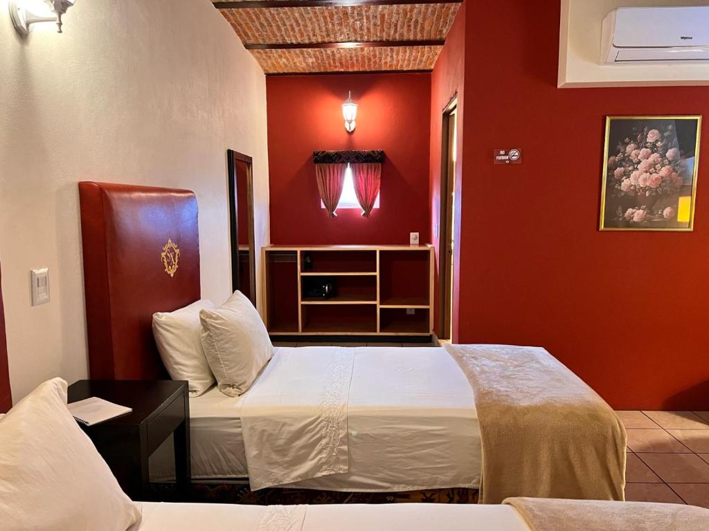 Postel nebo postele na pokoji v ubytování Hotel & Eventos Xalos