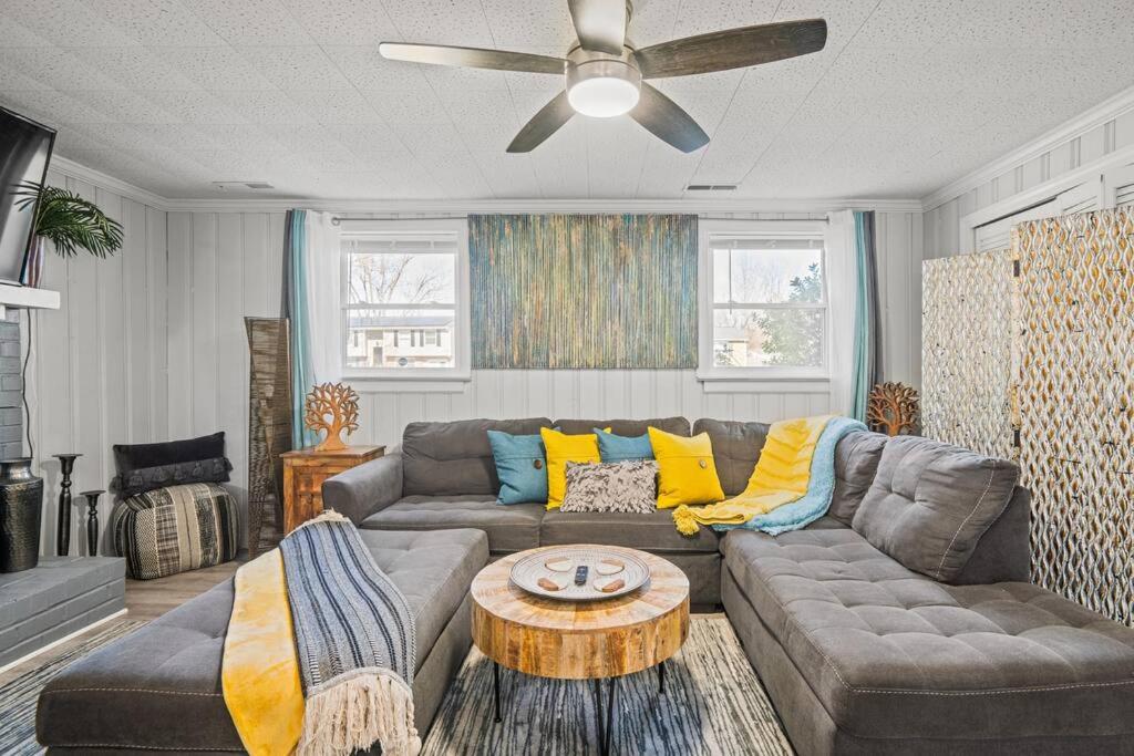 a living room with a couch and a ceiling fan at Stylish Haven 11 Minutes from the Richmond Airport in Richmond