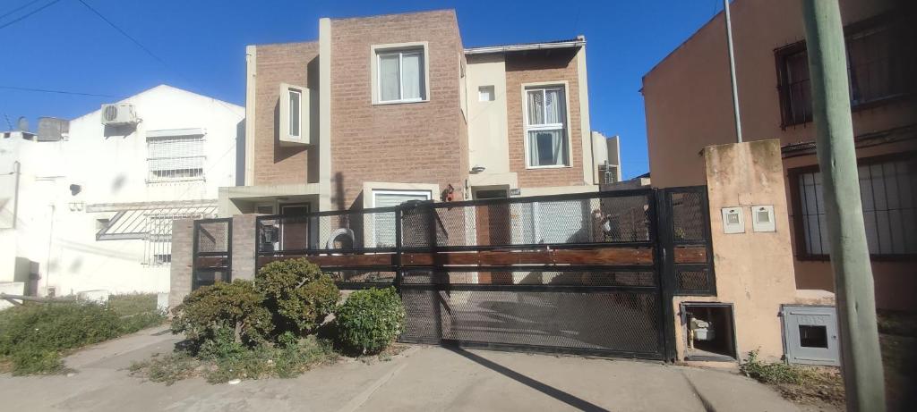 a house with a balcony in front of a building at Andrés Arro in Viedma