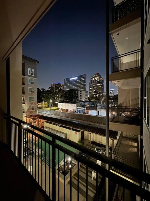 a view of a city at night from a balcony at Vacation Rental Home with Pool/Skyline View Near Galleria Mall in Houston