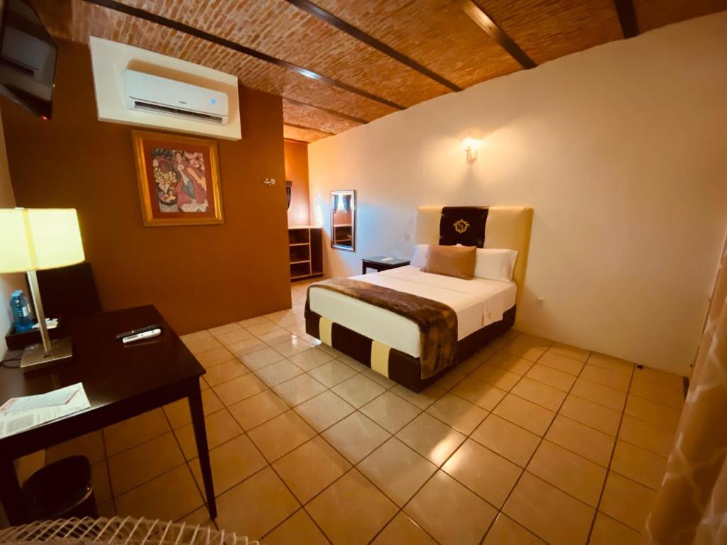 Postel nebo postele na pokoji v ubytování Hotel & Eventos Xalos