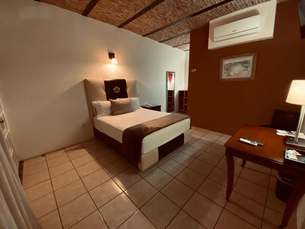 Postel nebo postele na pokoji v ubytování Hotel & Eventos Xalos