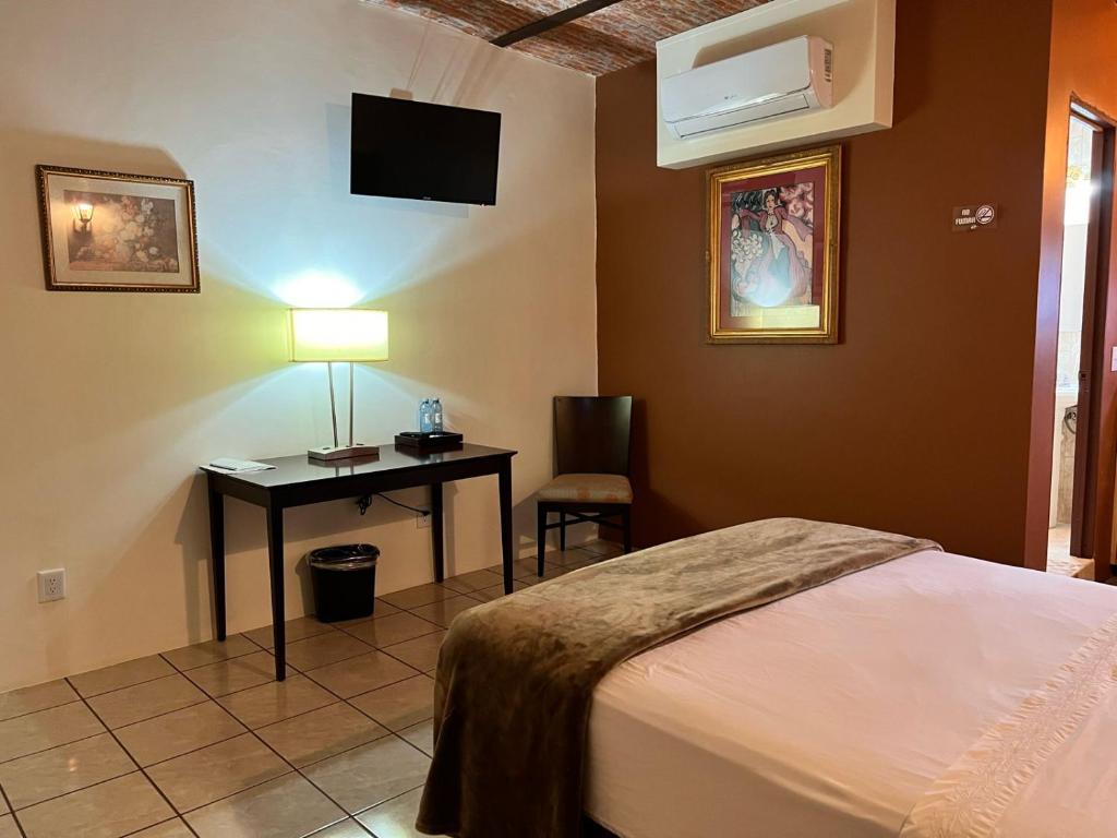Postel nebo postele na pokoji v ubytování Hotel & Eventos Xalos