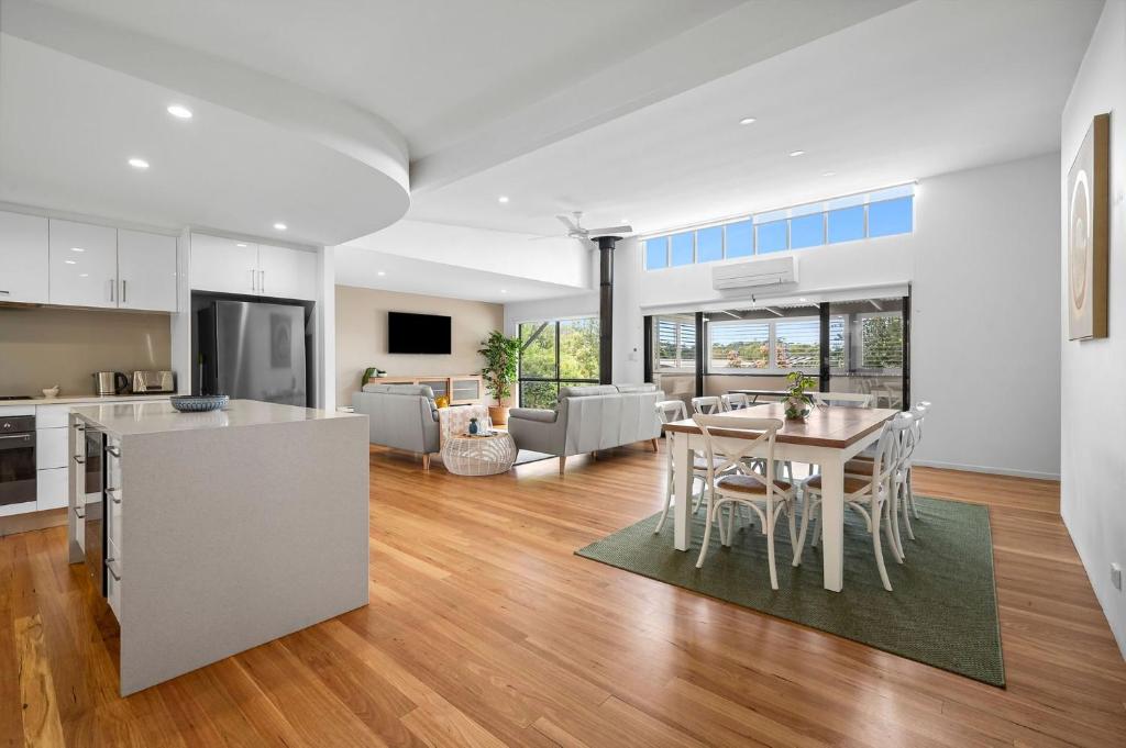 a kitchen and living room with a table and chairs at 153 Centenary Heights Rd in Yaroomba