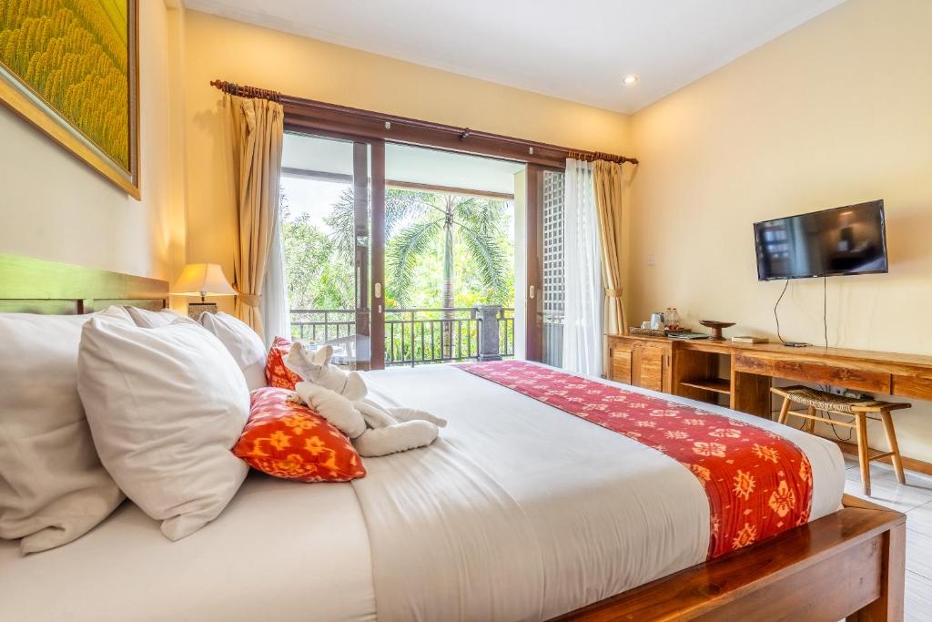 Postel nebo postele na pokoji v ubytování Meruhdani Boutique Hotel Ubud