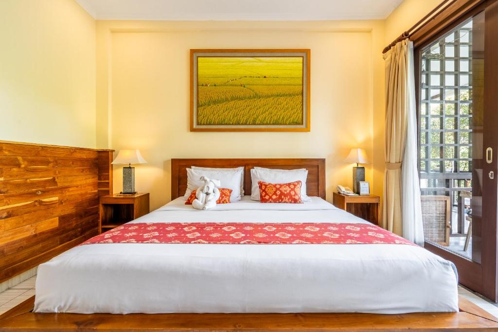 Postel nebo postele na pokoji v ubytování Meruhdani Boutique Hotel Ubud