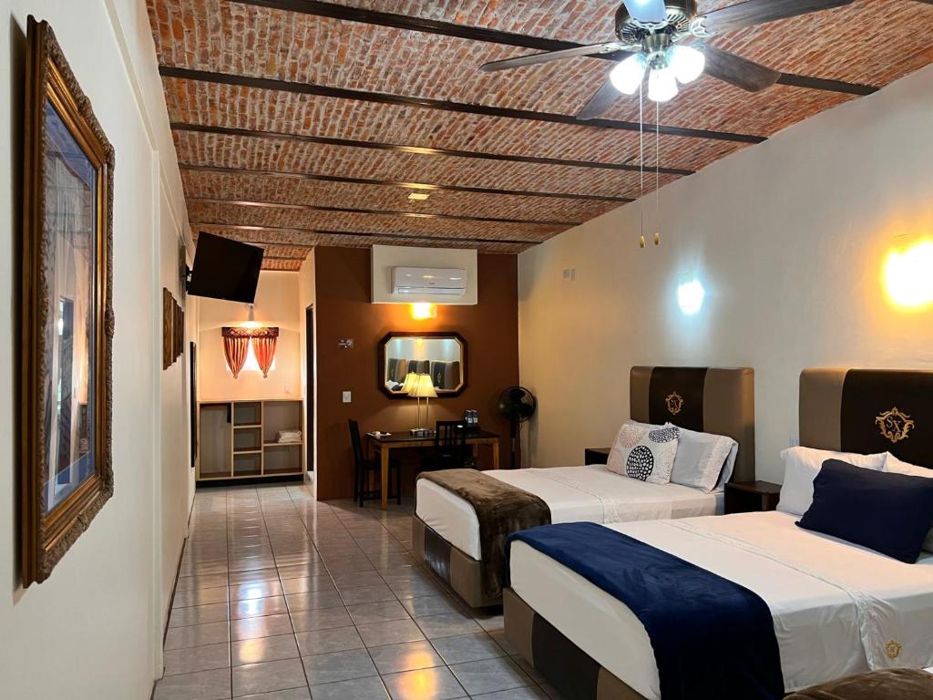 Postel nebo postele na pokoji v ubytování Hotel & Eventos Xalos