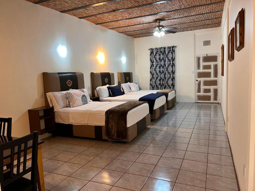 Postel nebo postele na pokoji v ubytování Hotel & Eventos Xalos