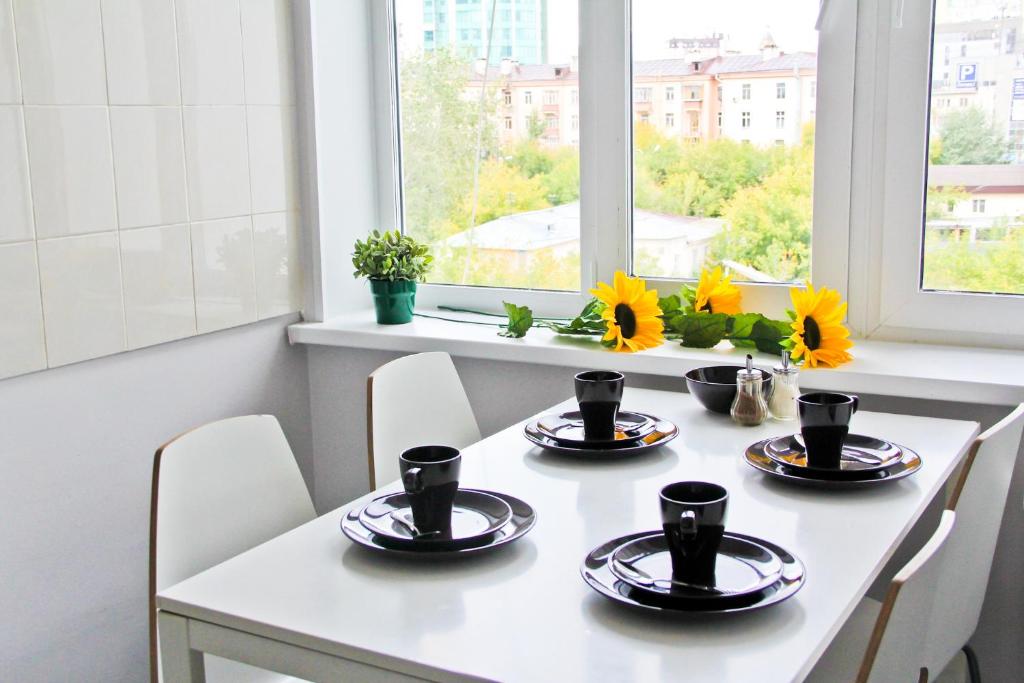 a dining room table with chairs and sunflowers on it at AHOSTEL in Yekaterinburg