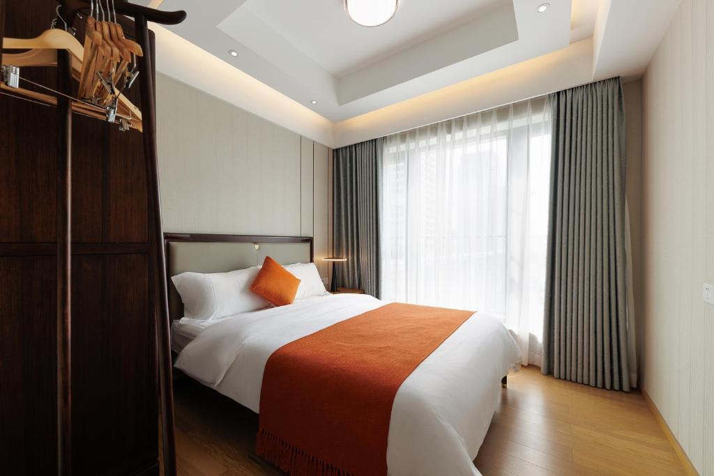 Postel nebo postele na pokoji v ubytování Doria Home International Apartment -Guangzhou Huijin IFC Keyun Road Metro Branch-Canton Fair Free Shuttle