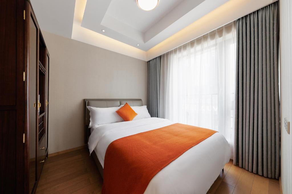 Postel nebo postele na pokoji v ubytování Doria Home International Apartment -Guangzhou Huijin IFC Keyun Road Metro Branch-Canton Fair Free Shuttle
