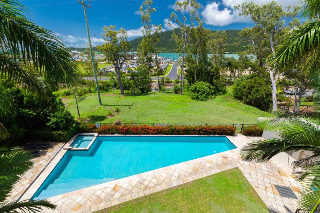 a swimming pool in the yard of a house at Le Jarden Vu Du Port in Airlie Beach