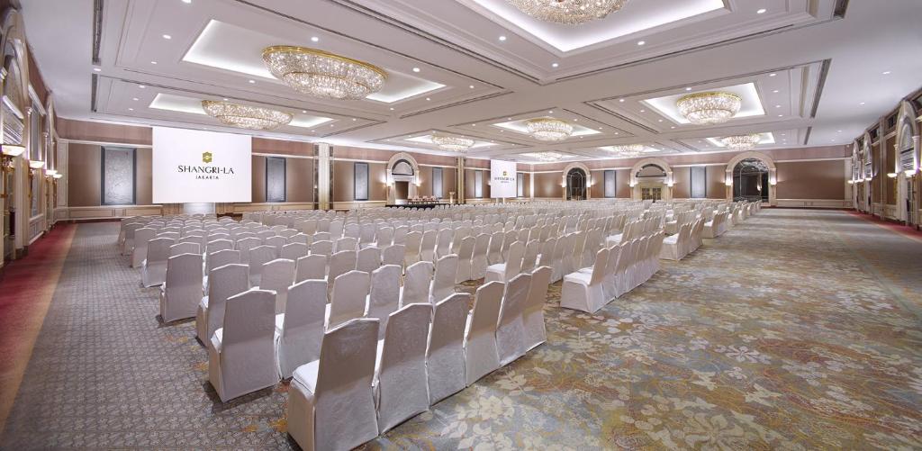 a large room with rows of chairs and a stage at Shangri-La Jakarta in Jakarta