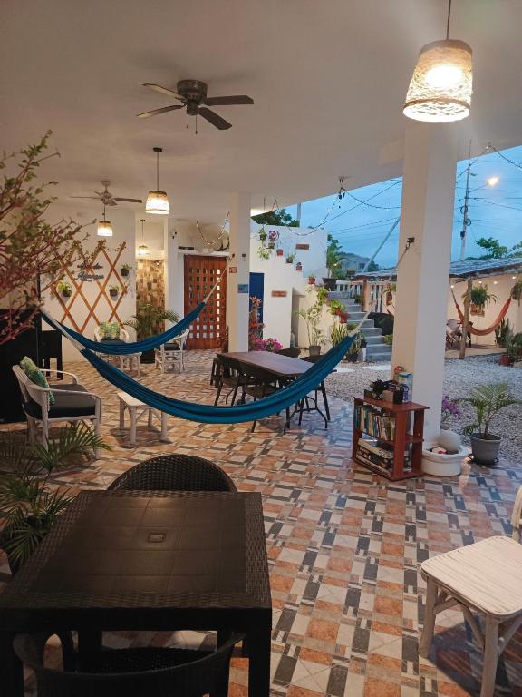 a patio with a hammock in the middle of a room at Sol de Ayangue in Ayangue