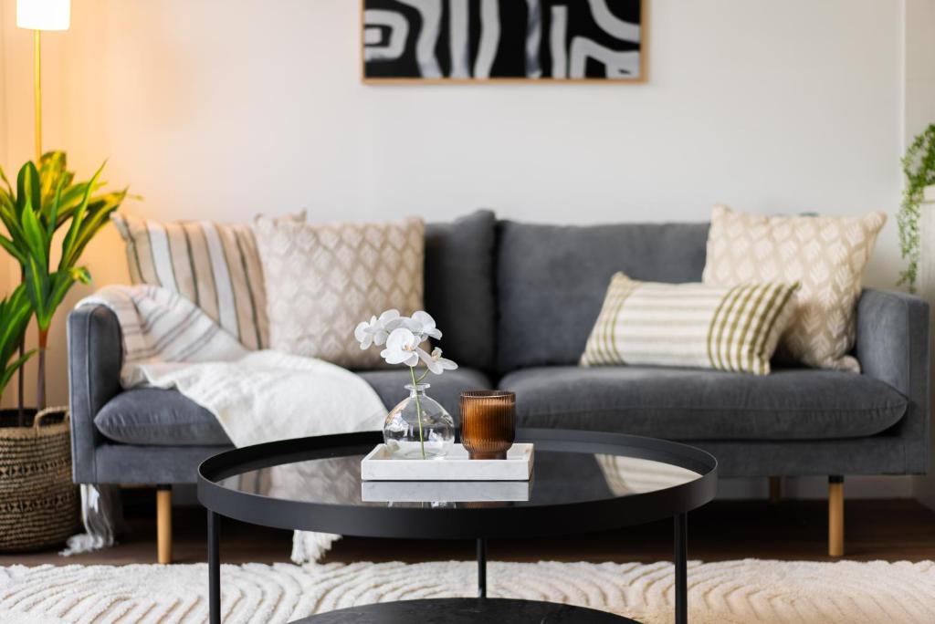 a living room with a couch and a coffee table at Balmoral Apartment - Airy & Light-filled City Edge Comfort Stay in Brisbane