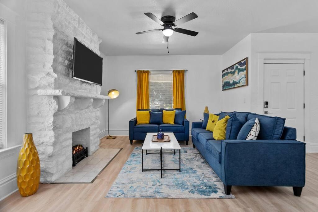 a living room with a blue couch and a fireplace at Modern Hyde Park HydeOut (FL1) in Kansas City