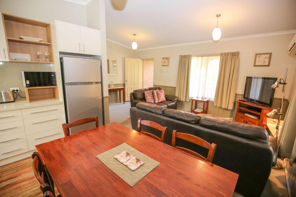 a kitchen and living room with a table and a couch at Silver Birches Holiday Village - Unit 6 in Bright