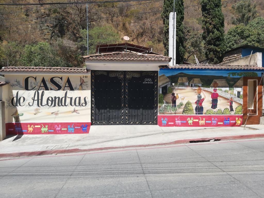 a building with a gate with a painting on it at Casa de Alondras in Panajachel