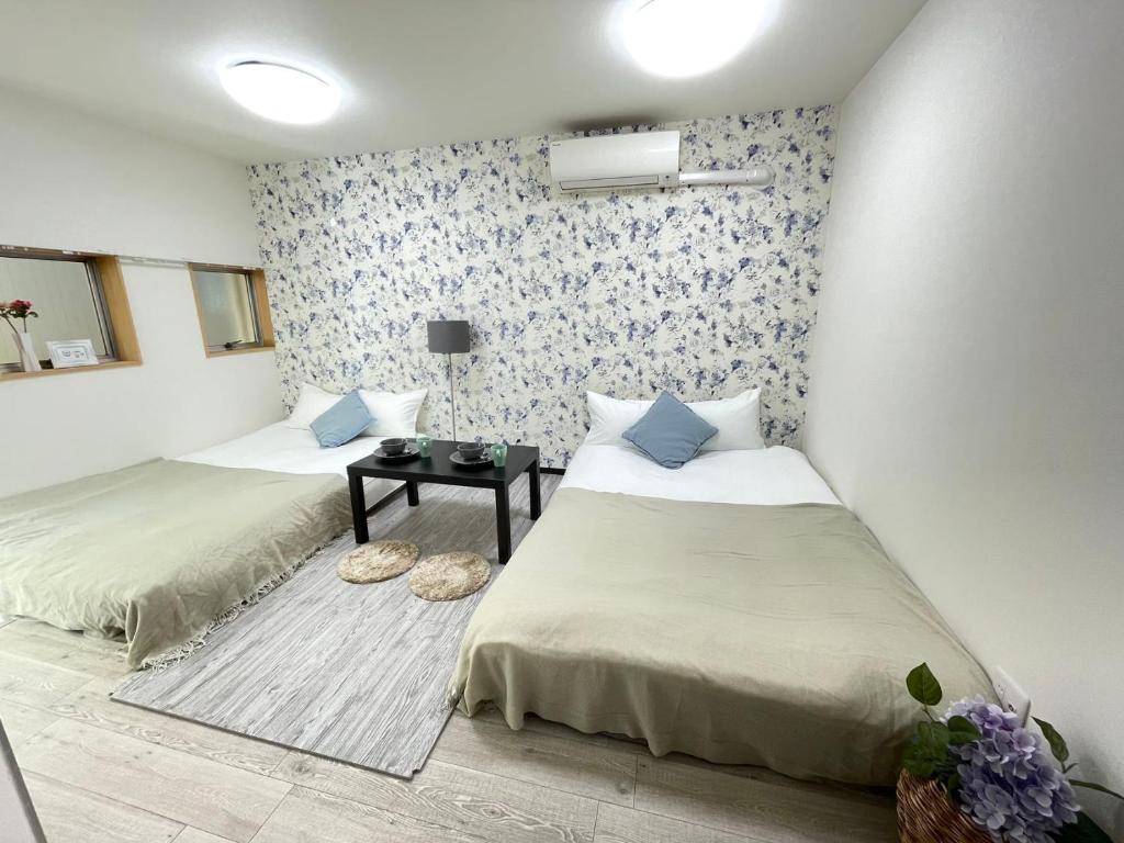 Postel nebo postele na pokoji v ubytování Comma House Minaminagasaki 101