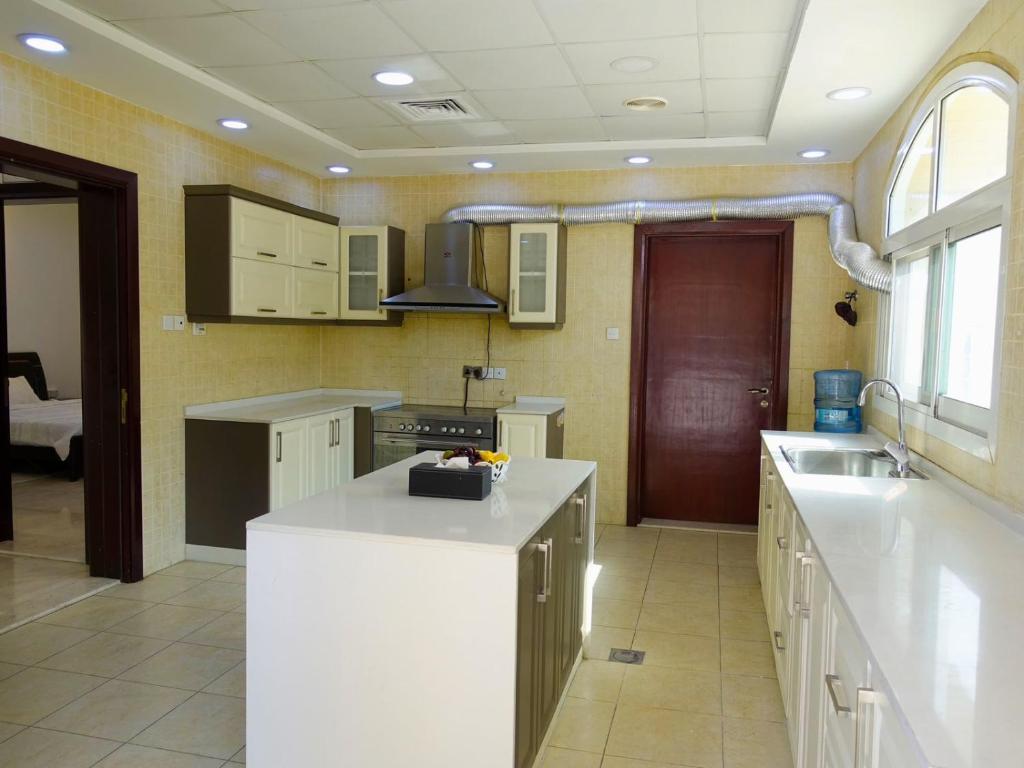 a kitchen with a white counter top in a room at Villa Room #3 in Umm Al Sheif in Dubai