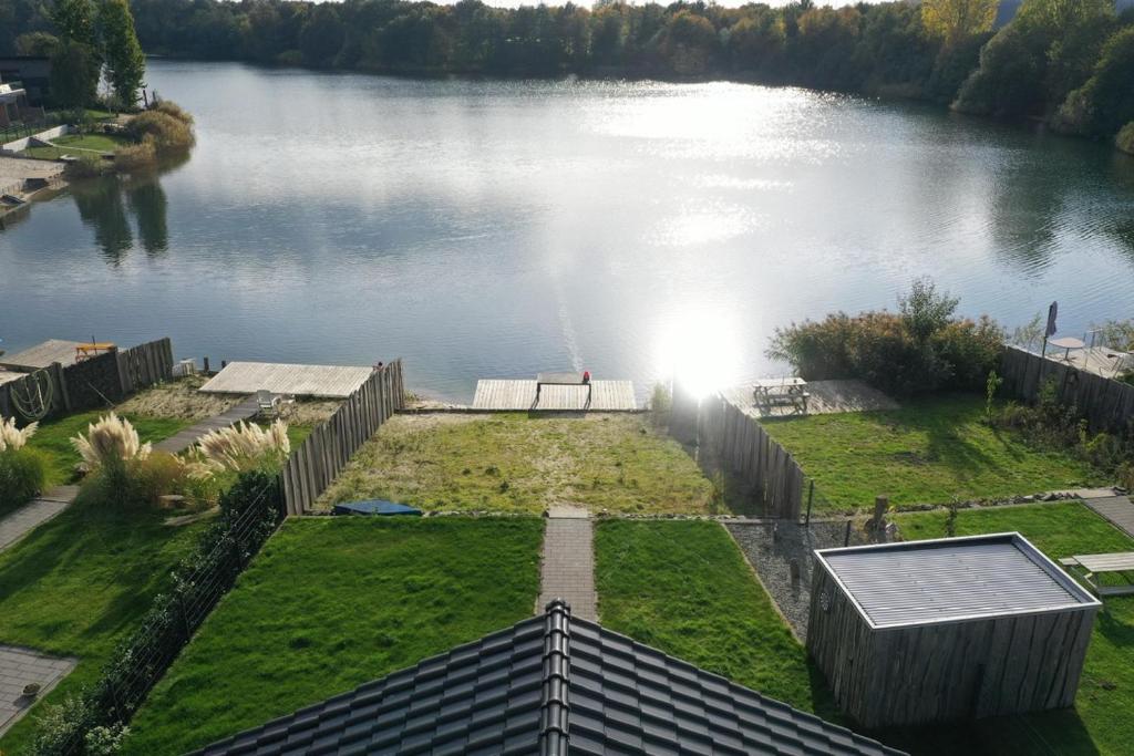 an aerial view of a lake with the sun shining on it at Haus am See in Barßel