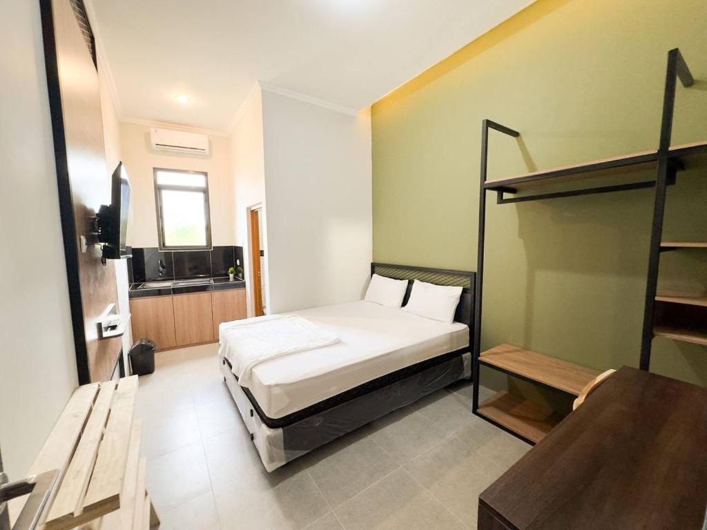 a bedroom with a bed and a bunk bed at AP Living Grand Kamala Lagoon Bekasi in Pekayon Satu