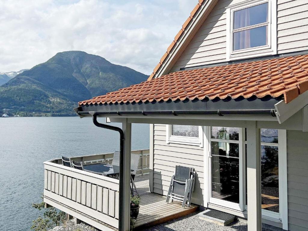 a house with a deck with a view of the water at Holiday home leikanger in Leikanger