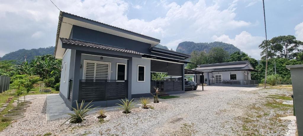 a small house with black shutters on it at Tambun Hillview Cottage in Tambun