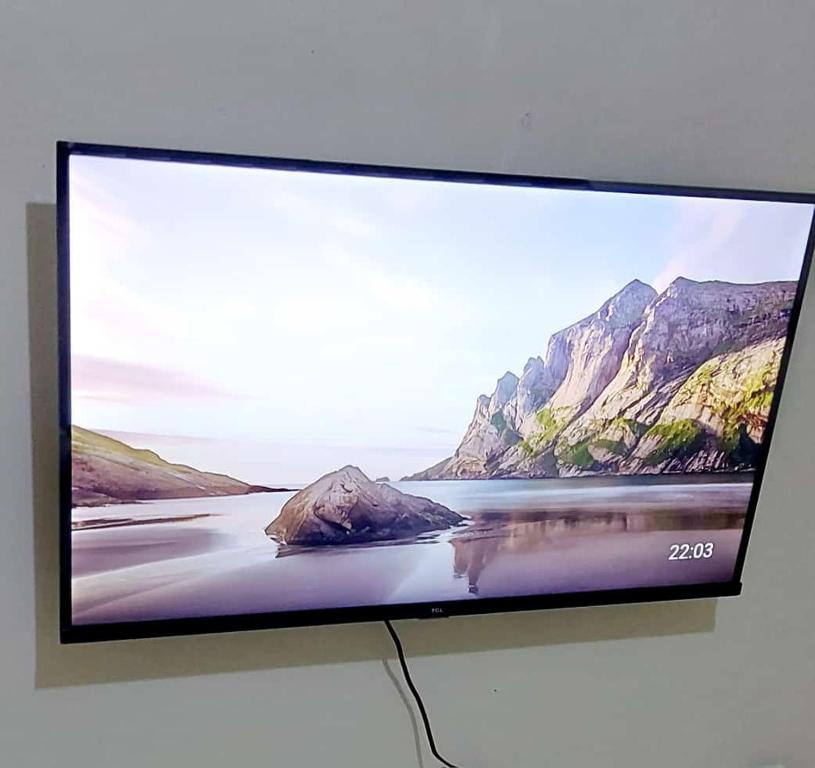 a flat screen tv sitting on top of a wall at Petnah Apartments in Ruiru