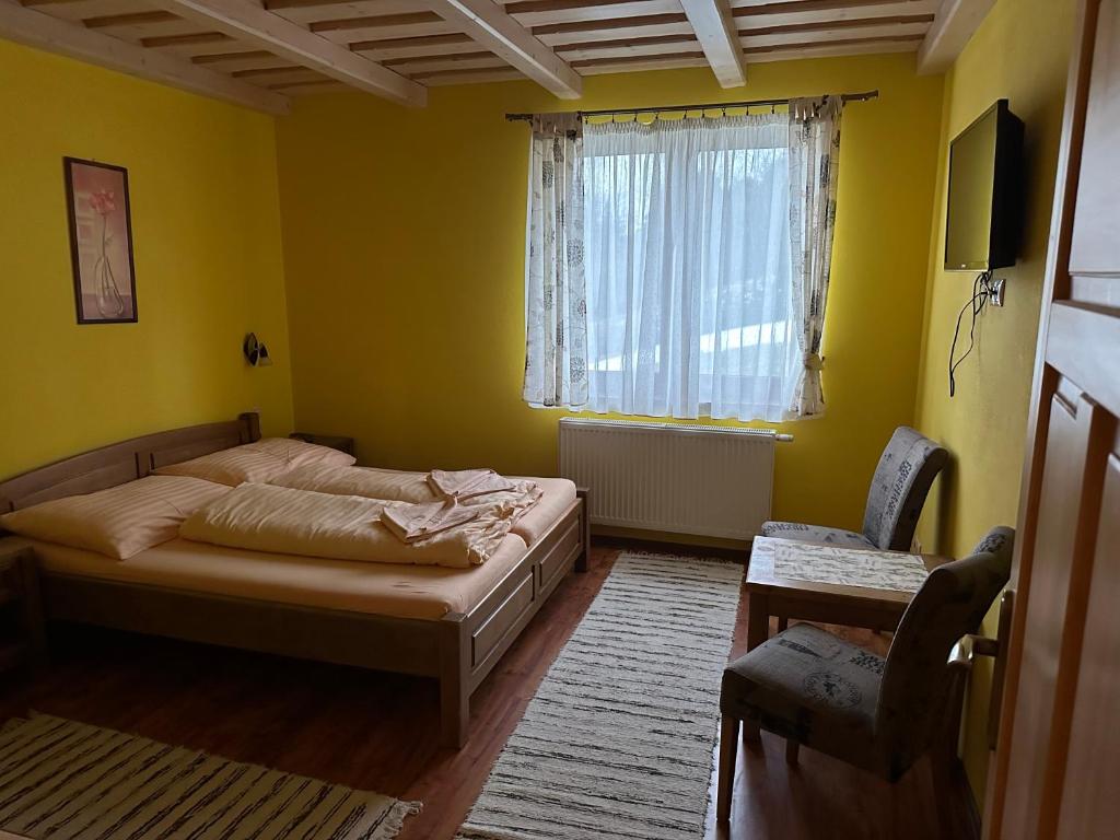 a bedroom with two beds and a window at Penzion Relax in Nižná