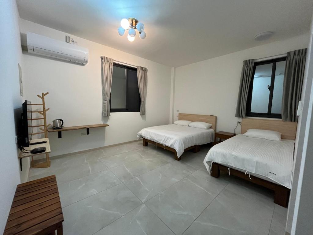Postel nebo postele na pokoji v ubytování 楠山民宿Nanshan Homestay