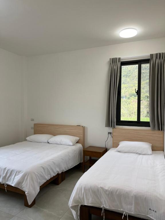 Postel nebo postele na pokoji v ubytování 楠山民宿Nanshan Homestay